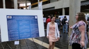 Students standing next to their poster