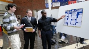 Students standing next to their poster