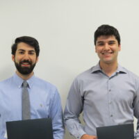 2 Students holding a school of business academic award