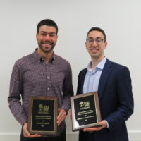 2 Students holding a school of business academic award