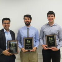 3 Students holding a school of business academic award