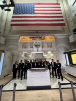 A large group of people standing next to each other at the New York Stock Exchange