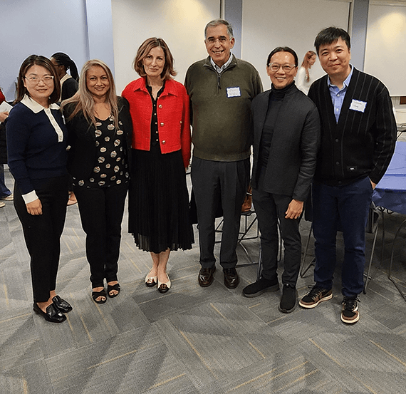 A group of people stand next to each other
