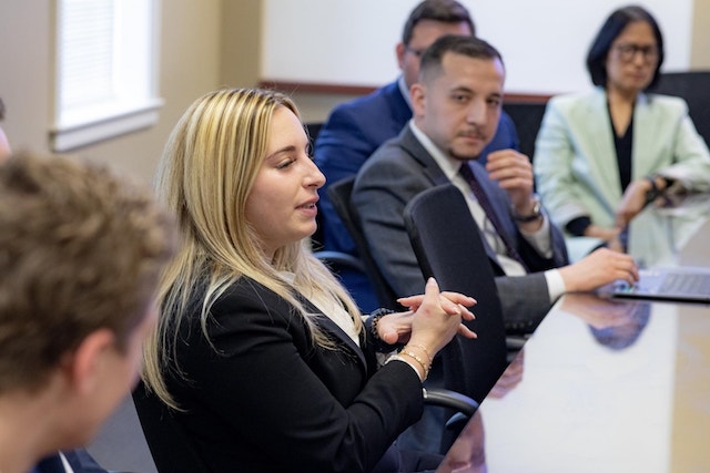graduate students sit around a conference table